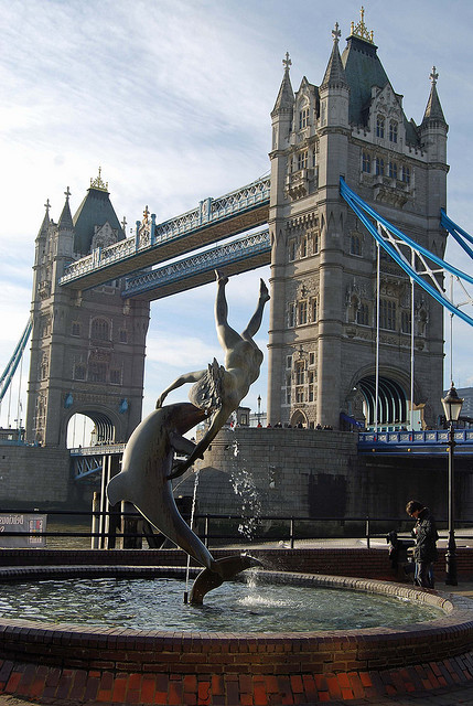 Dolphin statue and Tower Bridge, St Katherine’s dock, London, England